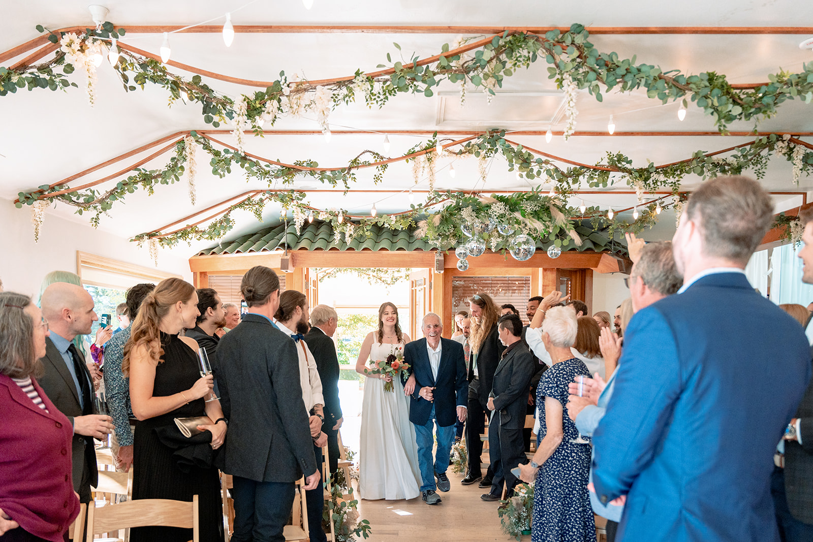 bride and her father walking down the aisle during wedding ceremony