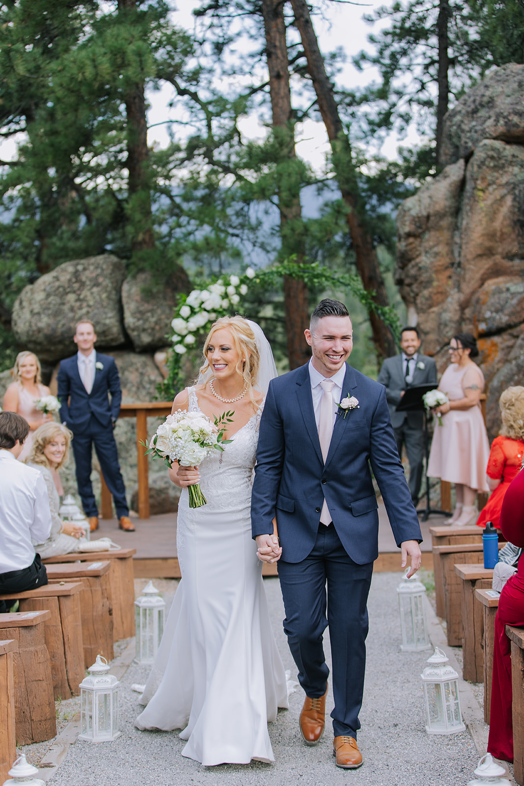 couple walking out of their wedding ceremony with big smiles on their faces