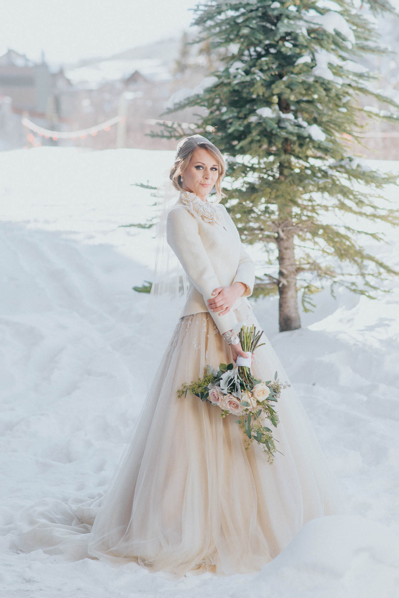 bride portrait snow winter coat blush dress